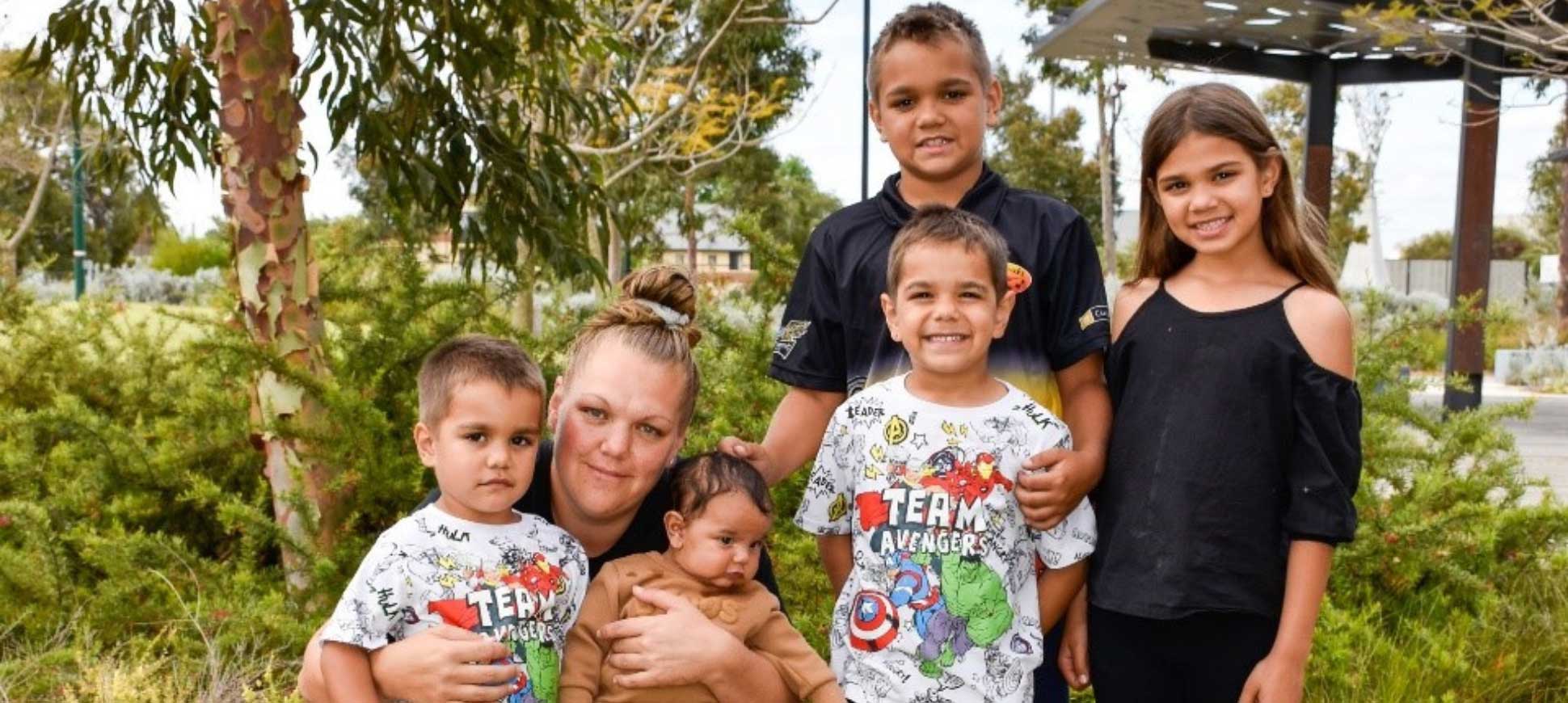 A mother and her five children smile for a photo