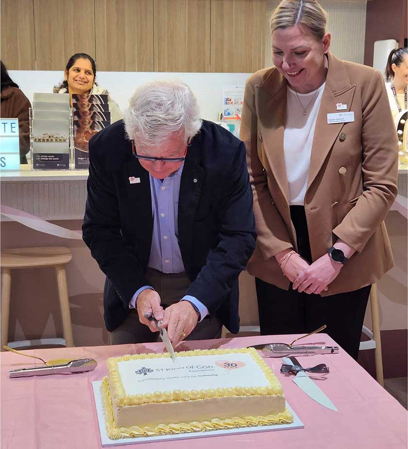 St John of God Foundation Board Chair Tony Howarth AO and CEO Bianca Pietralla cut the cake