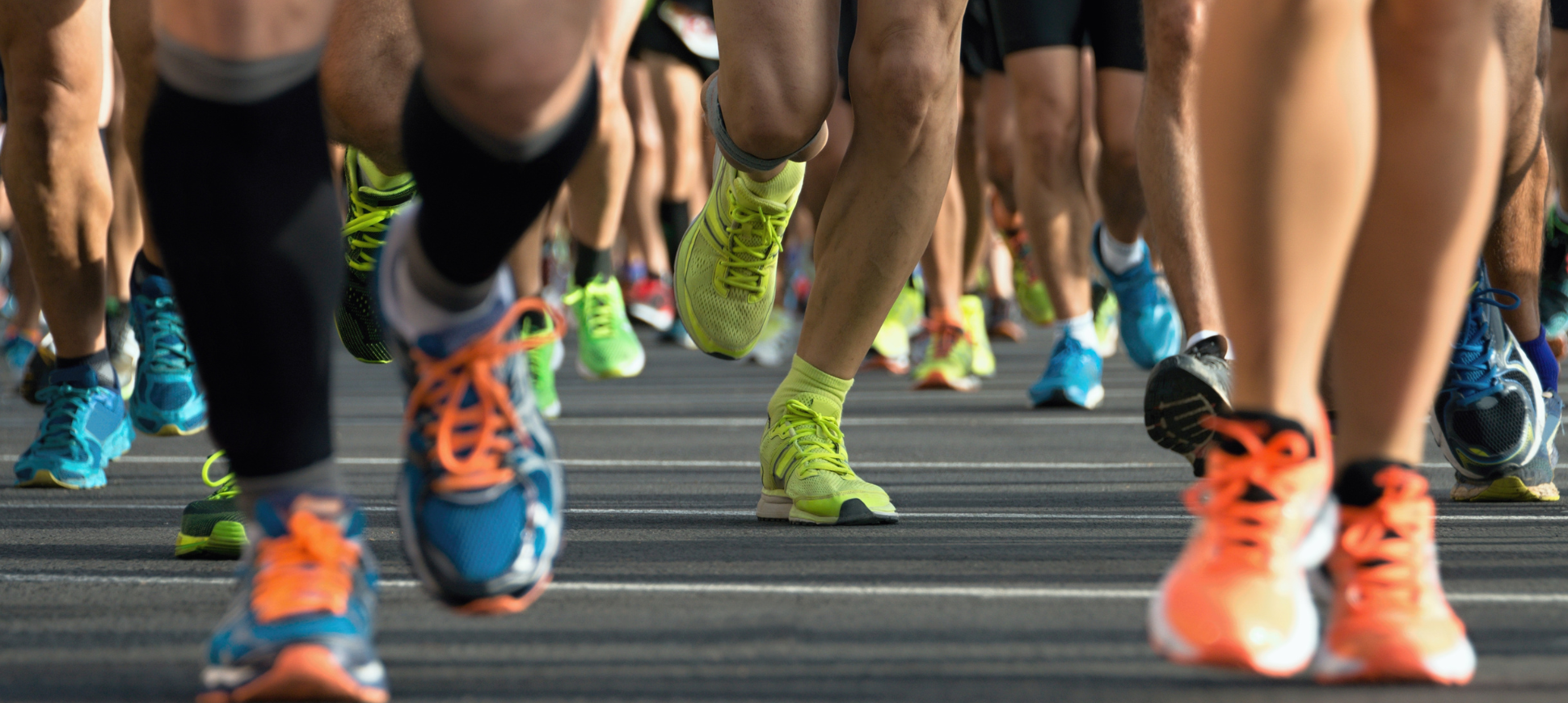 Image of people's legs in the middle of a marathon