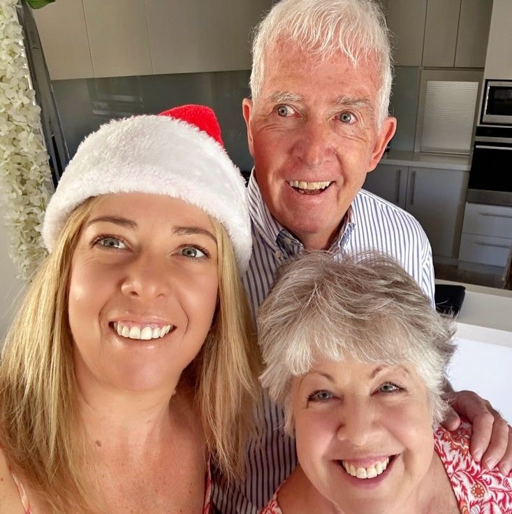 Image of Pauline Tew and family smiling on christmas day